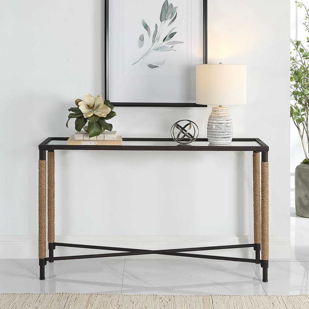 Console table with decorative items against a white wall