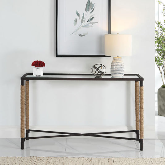 Console table with glass top and woven sides on a white background