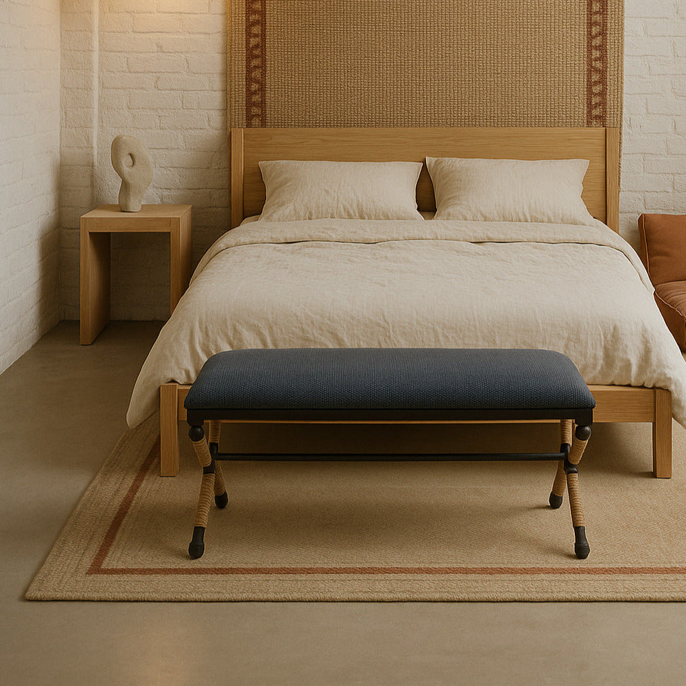 Bedroom with a wooden bed, wicker headboard, and bench.