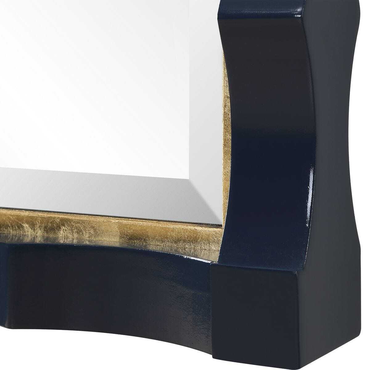 Close-up of a decorative mirror with a dark blue frame and gold accents.