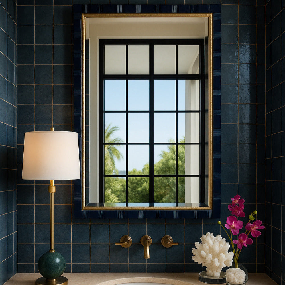 Bathroom with blue tiled walls, a sink, and decorative elements.