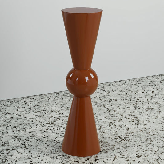 Modern pedestal side table in living room in Terra Cotta with a drink on top with a decorative arm chair.