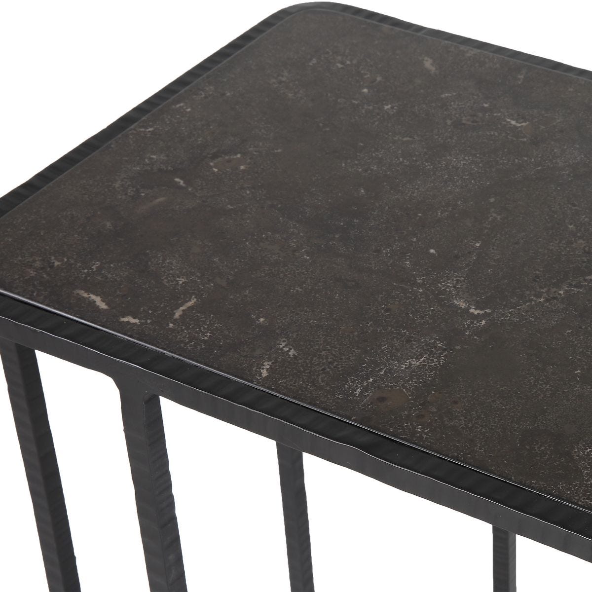 Black marble side table with a textured surface on a white background