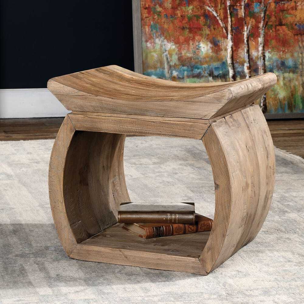 Wooden stool with a shelf on a gray rug in front of a colorful abstract painting.