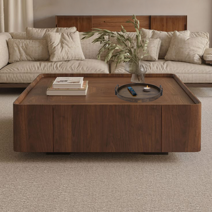 Wooden tray with handles on a square ottoman in natural wood and with a plant.