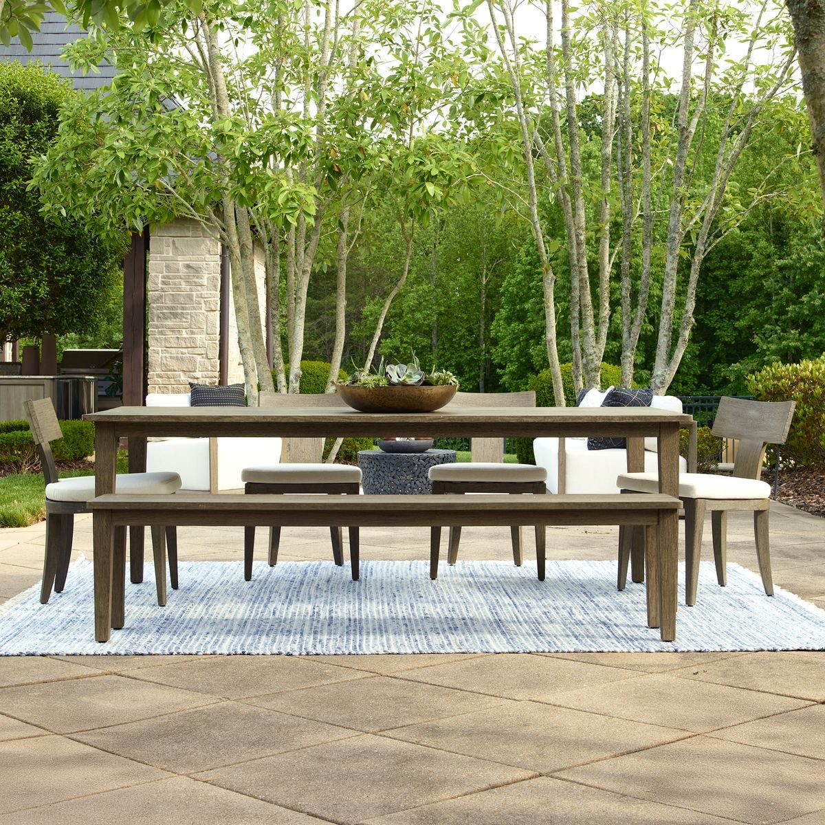 Outdoor farmhouse dining table set for dinner.