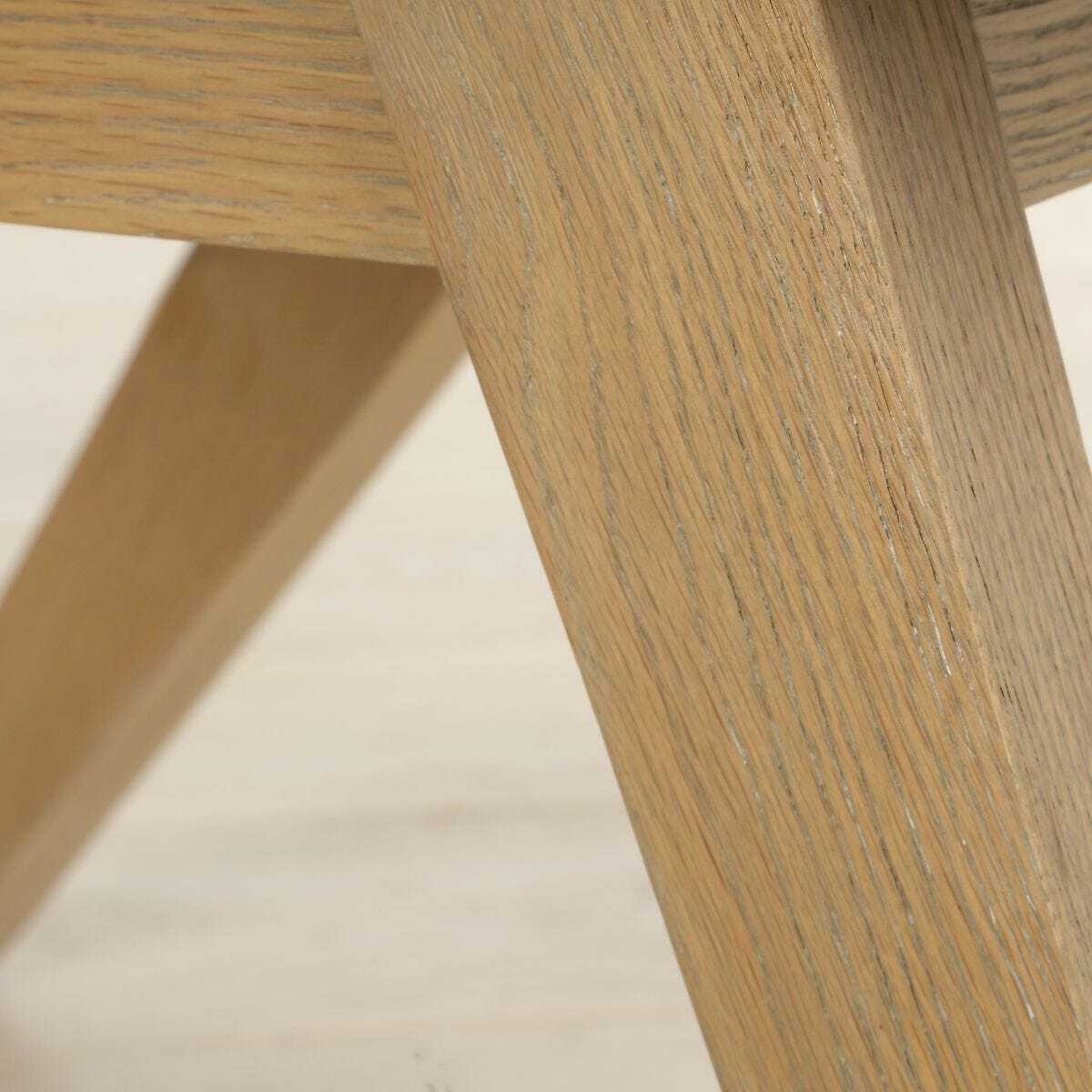 Close-up of a wooden chair leg on a light background