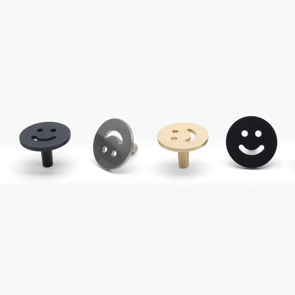 Set of six smiley face-shaped door knobs on a white background