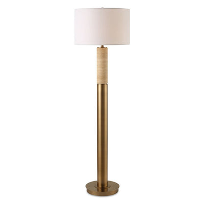 Floor lamp with a gold base and white shade on a white background