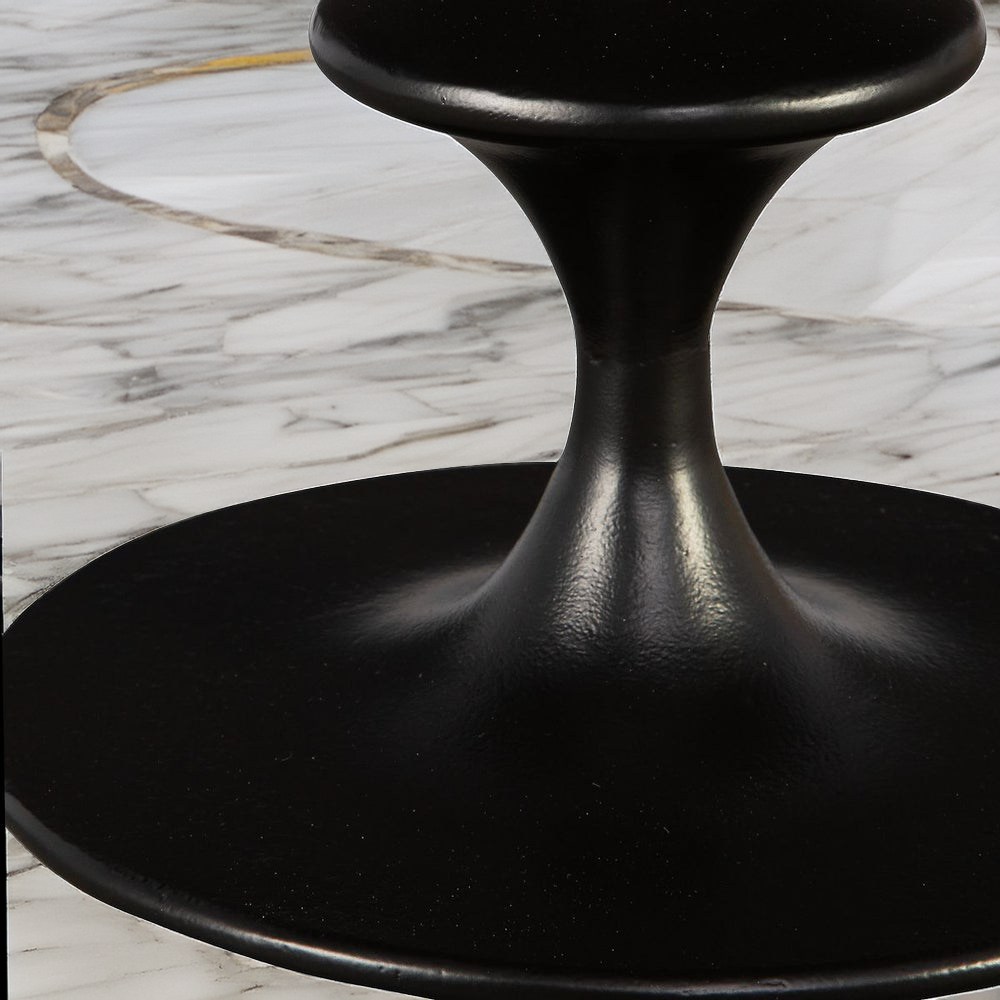 Stem of round black metal accent table.