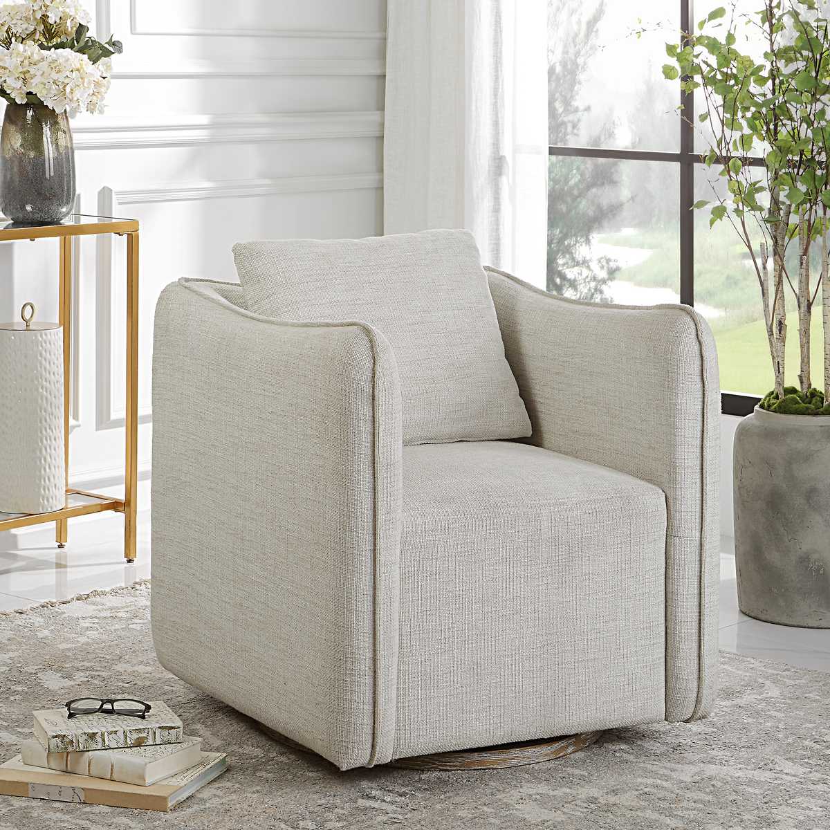 Beige armchair in a modern living room with decor elements.