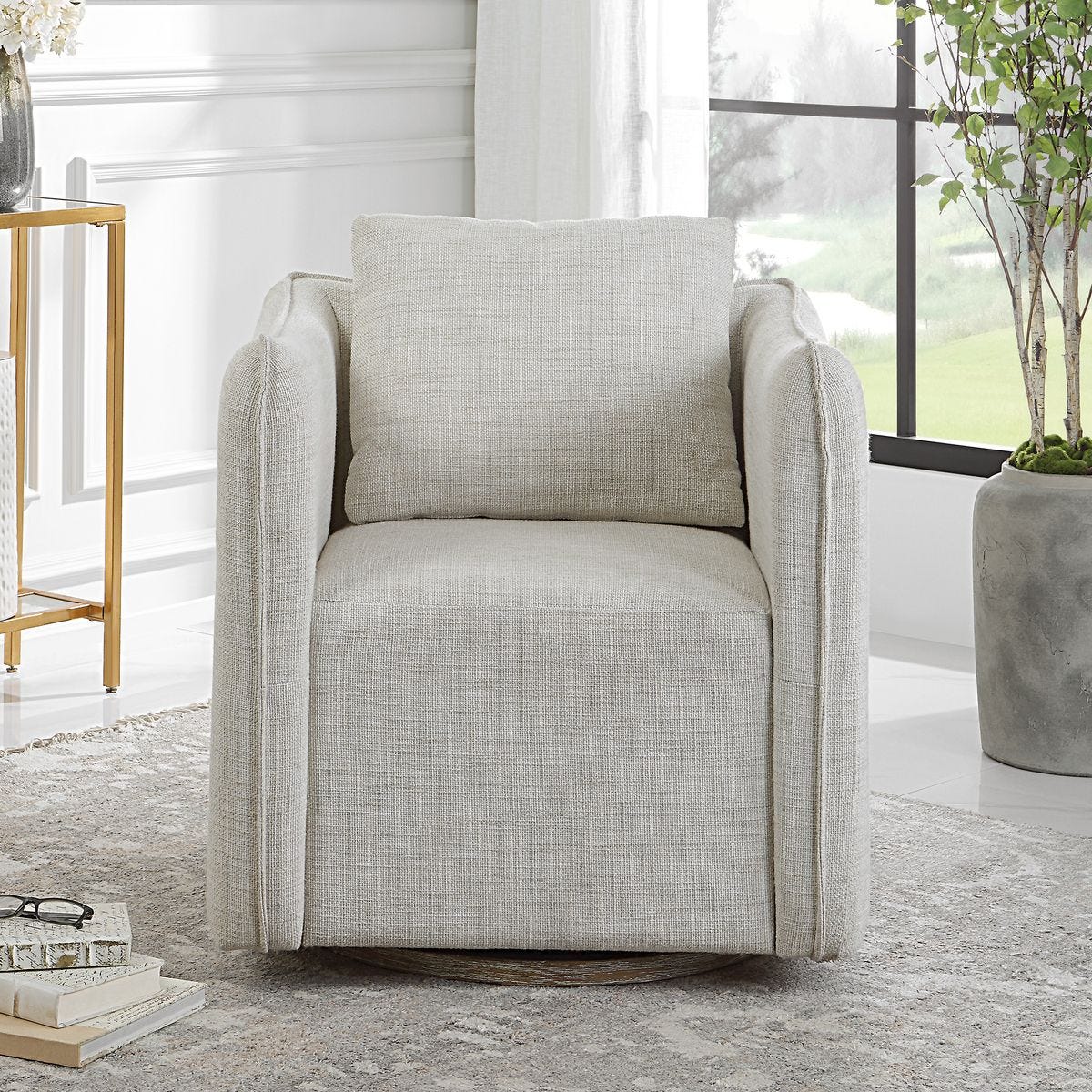 Gray armchair in a modern living room with decor elements.