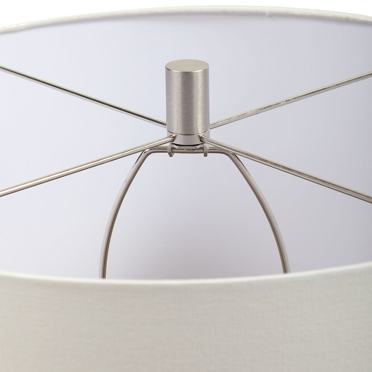 Close-up of a lamp with a metallic base and white shade
