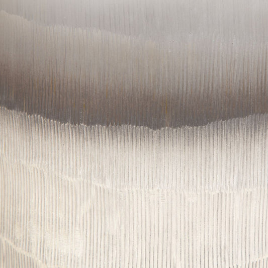 Japandi textured vases that are gold and beige on a coffee table in a living room.