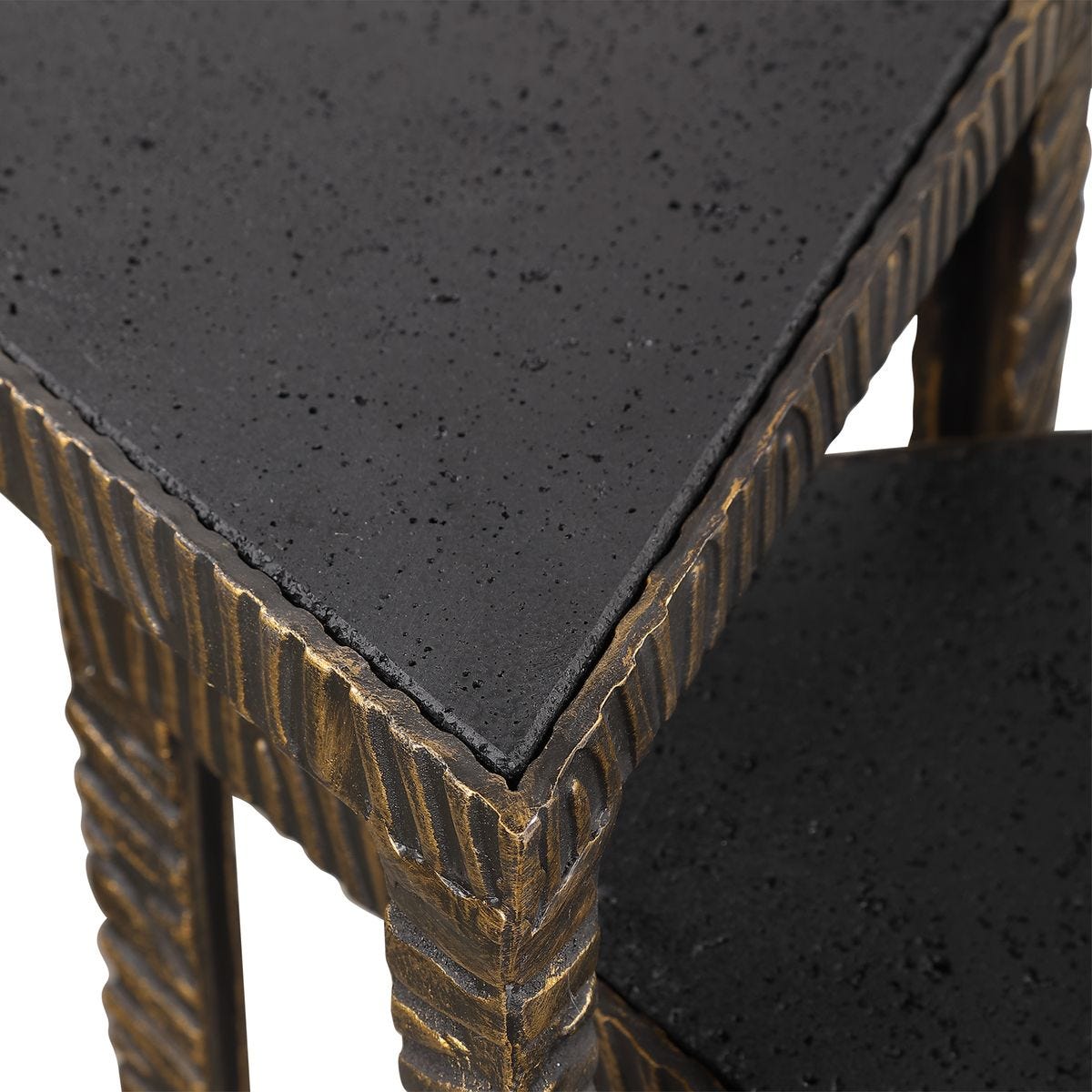 Close-up of a textured black surface with intricate bronze patterns on the edges.
