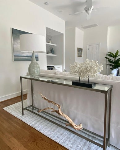Coastal Living Room with Slender Silver Console Table with Decorative Coral and Driftwood Sculpture.