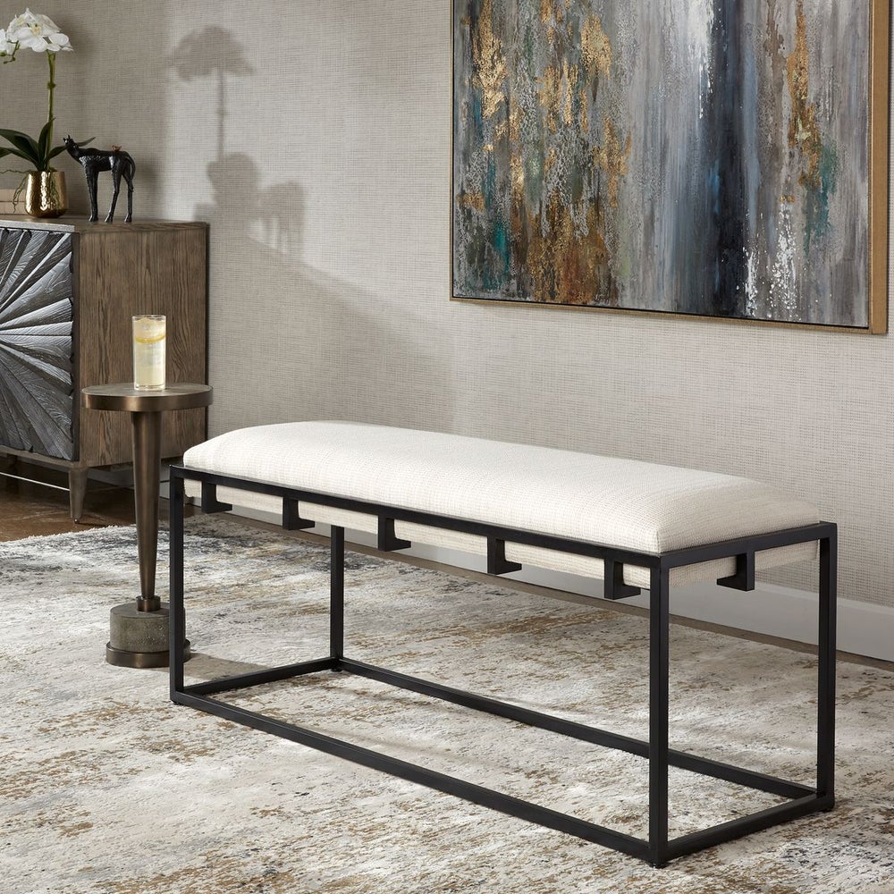 Upholstered entry bench with white cushion.