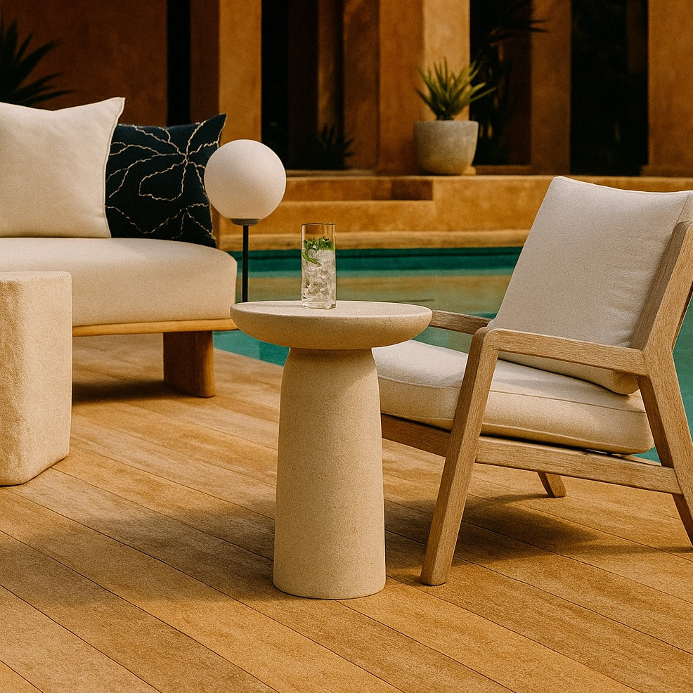 Modern outdoor furniture set with a table, chairs, and cushions by a pool.