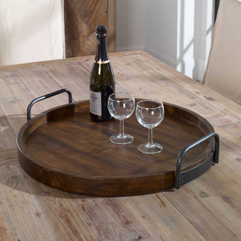 Wooden tray with a bottle of wine and two glasses on a wooden table.