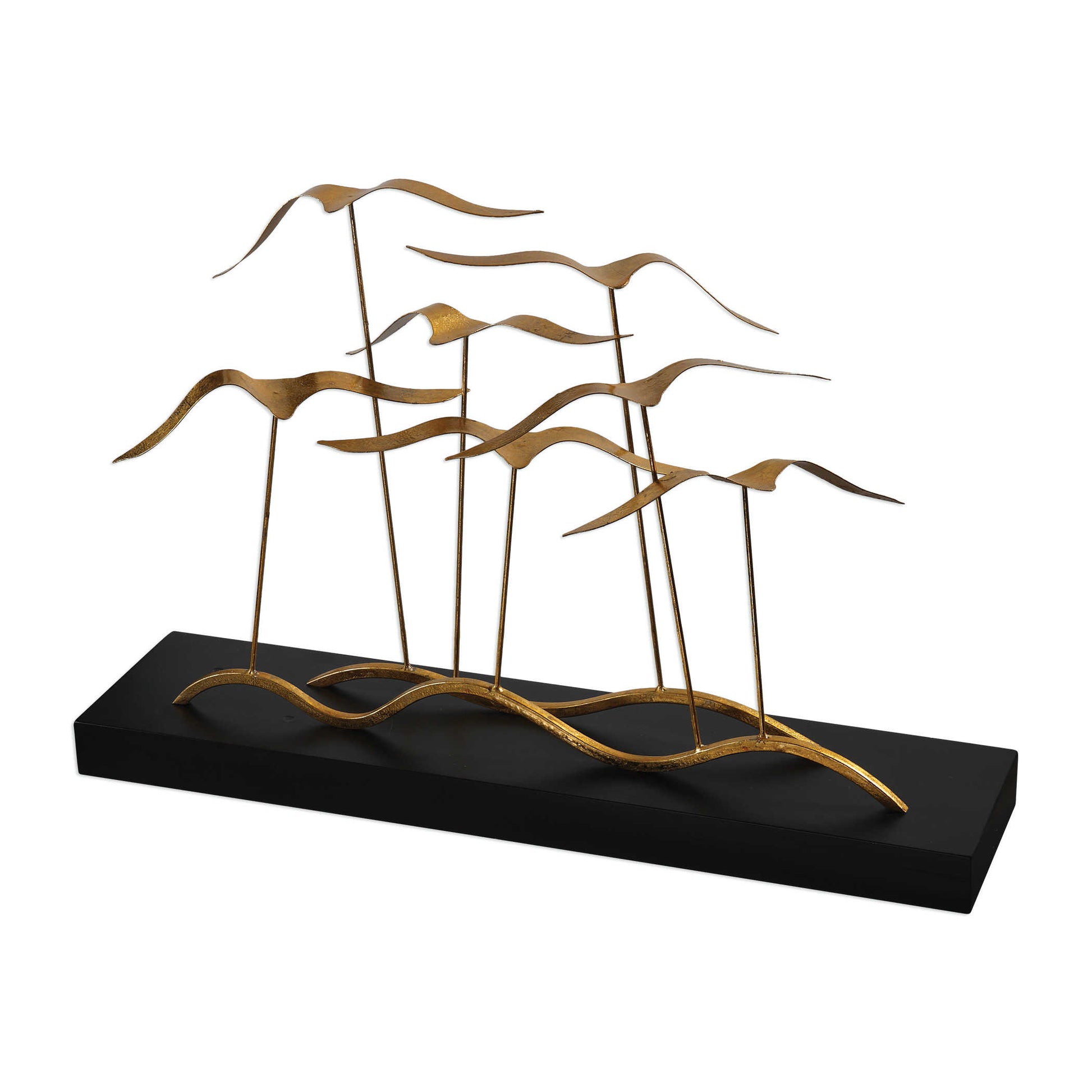 Flock of seagulls, finished in a metallic gold leaf, flying above an aged black distressed wood base.