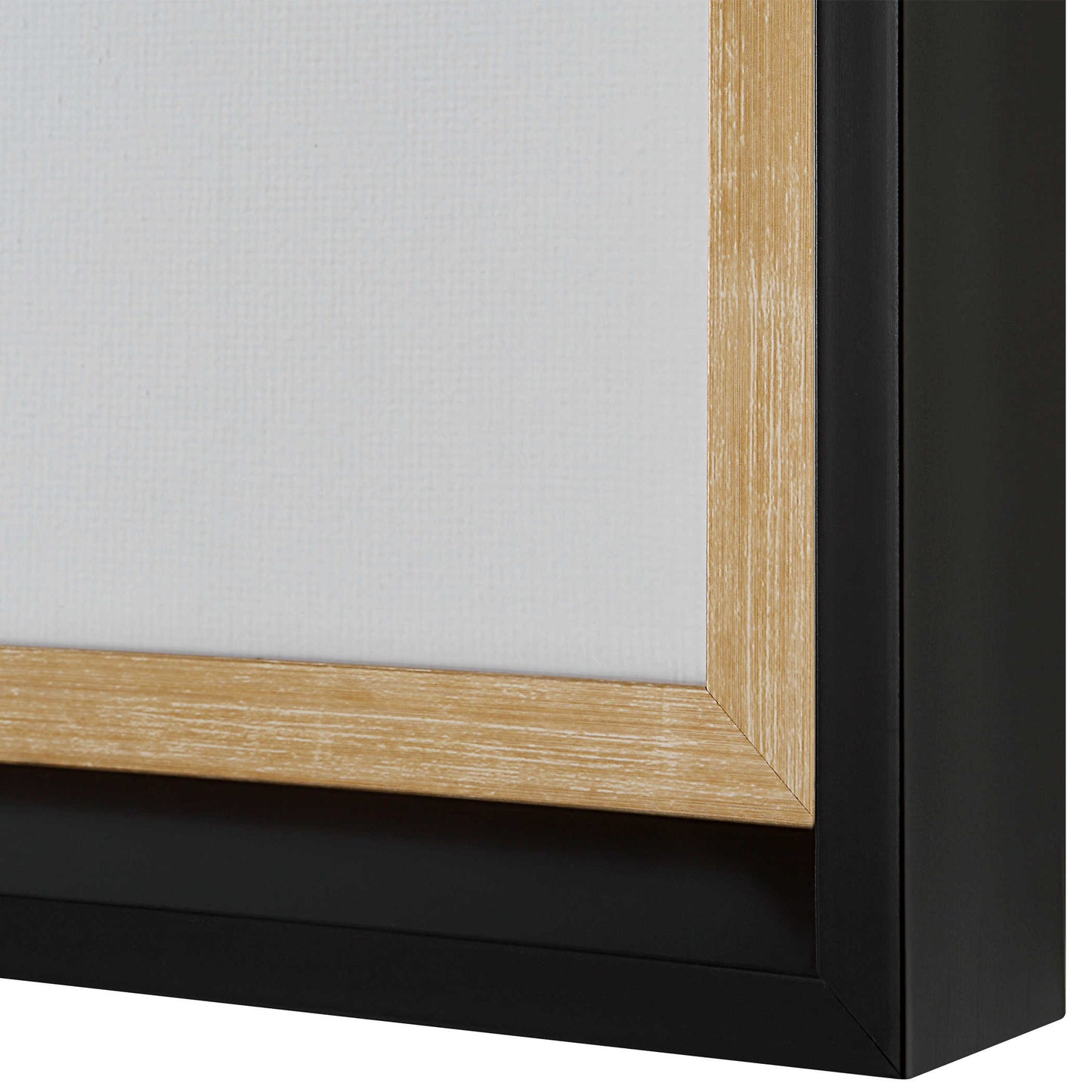 Close up shot of the corner of the black frame and aged gold inner lip.