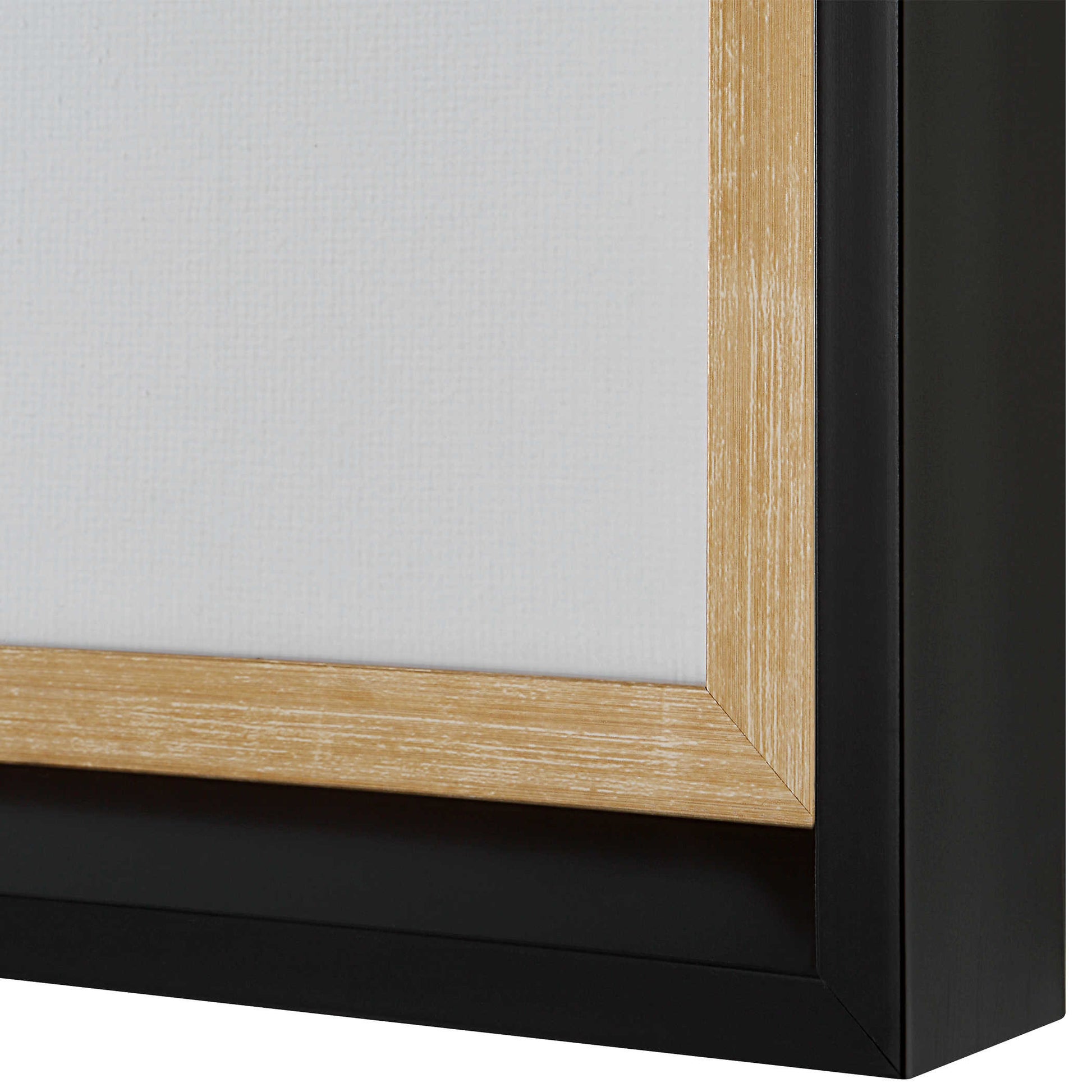 Close up shot of the corner of the black frame and aged gold inner lip.