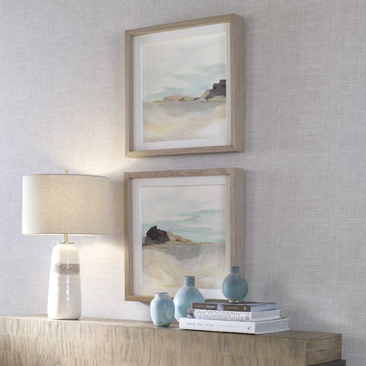 Two coastal art prints in from of a yellow chair in a modern, luxury Newport Beach home.