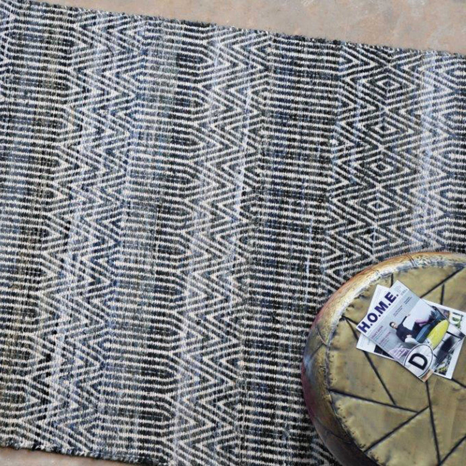 geometric rug with side table on top and two magazines