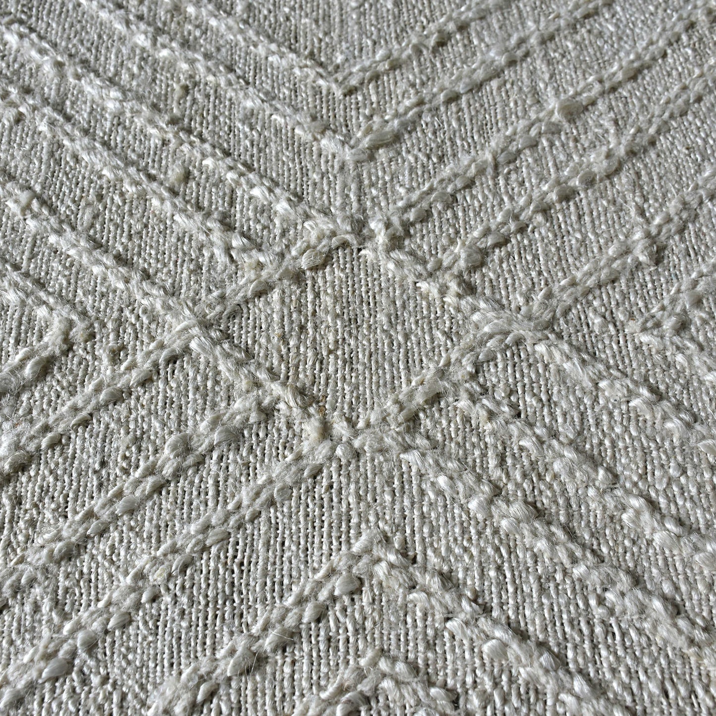 Raised geometric white pattern of the wool white rug.