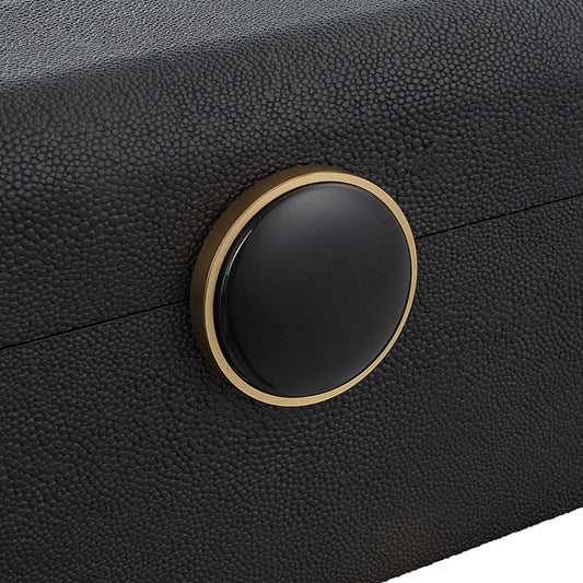 sleek black shagreen box on a mirrored console with wallet and keys