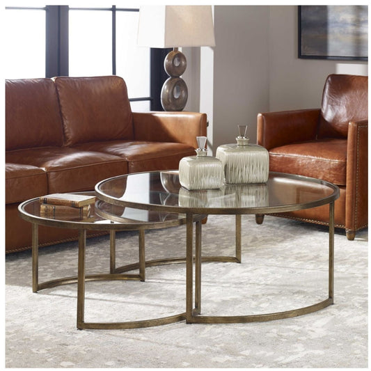 Set of two gold nesting coffee tables in a luxurious living room setting.