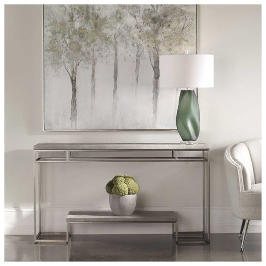 This console features faux shagreen embossed surfaces in a natural light gray wash, paired with a modern, stainless steel frame finished in brushed nickel.
