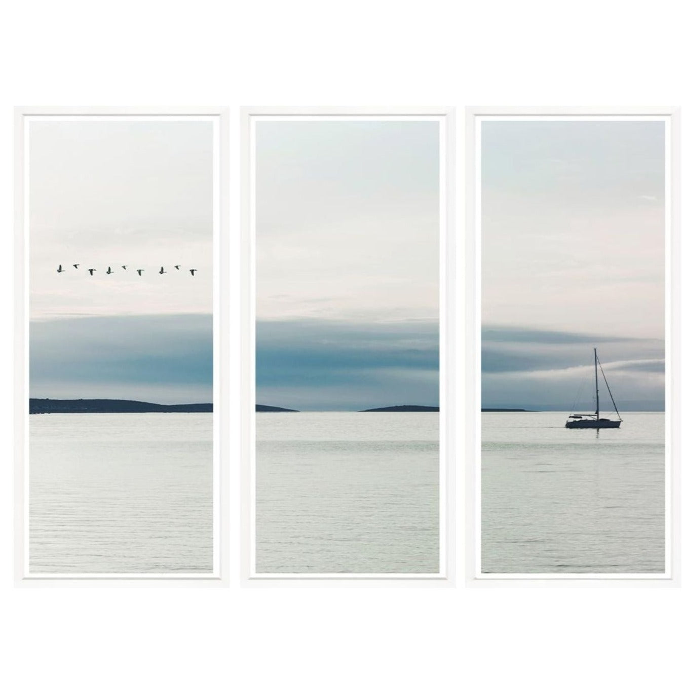 3 art boards of smooth ocean with sail boat, clouds in sky and a flock of birds flying overhead.