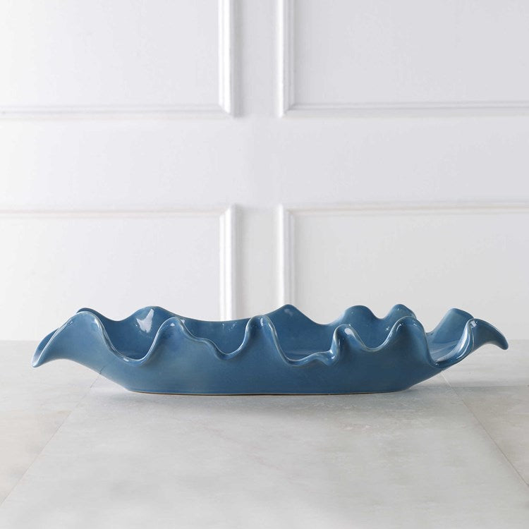 Blue decorative tray on stone countertop.