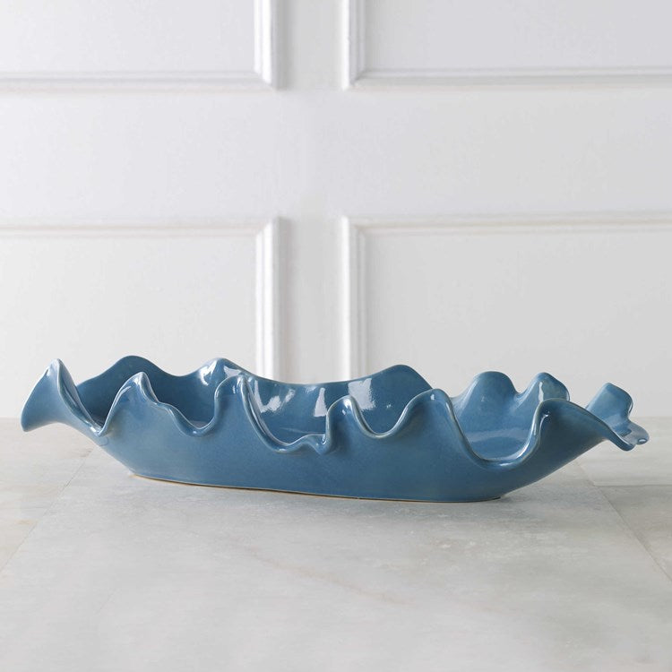This blue ceramic tray is a beautiful way to accessorize a table and hold various objects and accessories.
