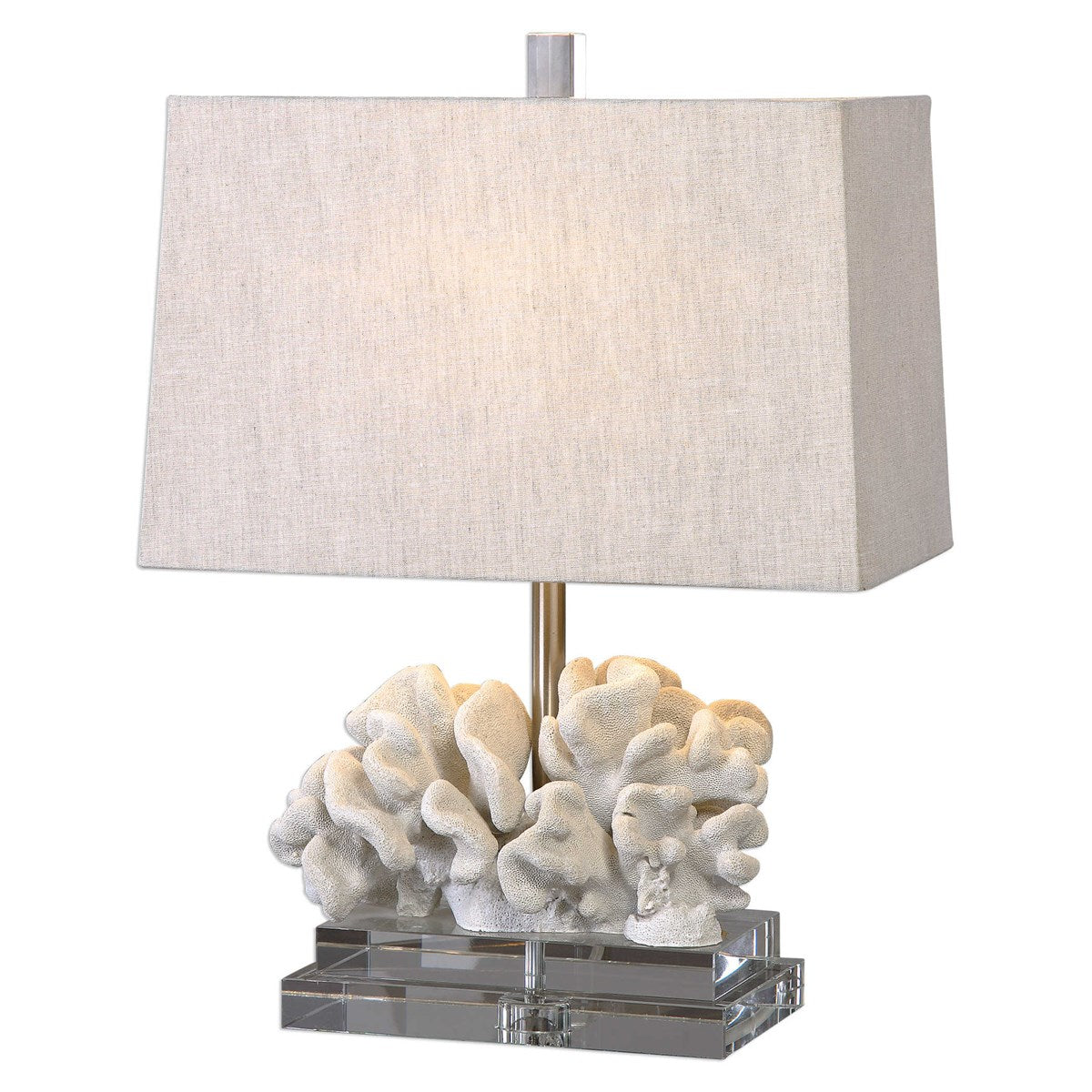 Coral table lamp shot in studio lighting with light on.