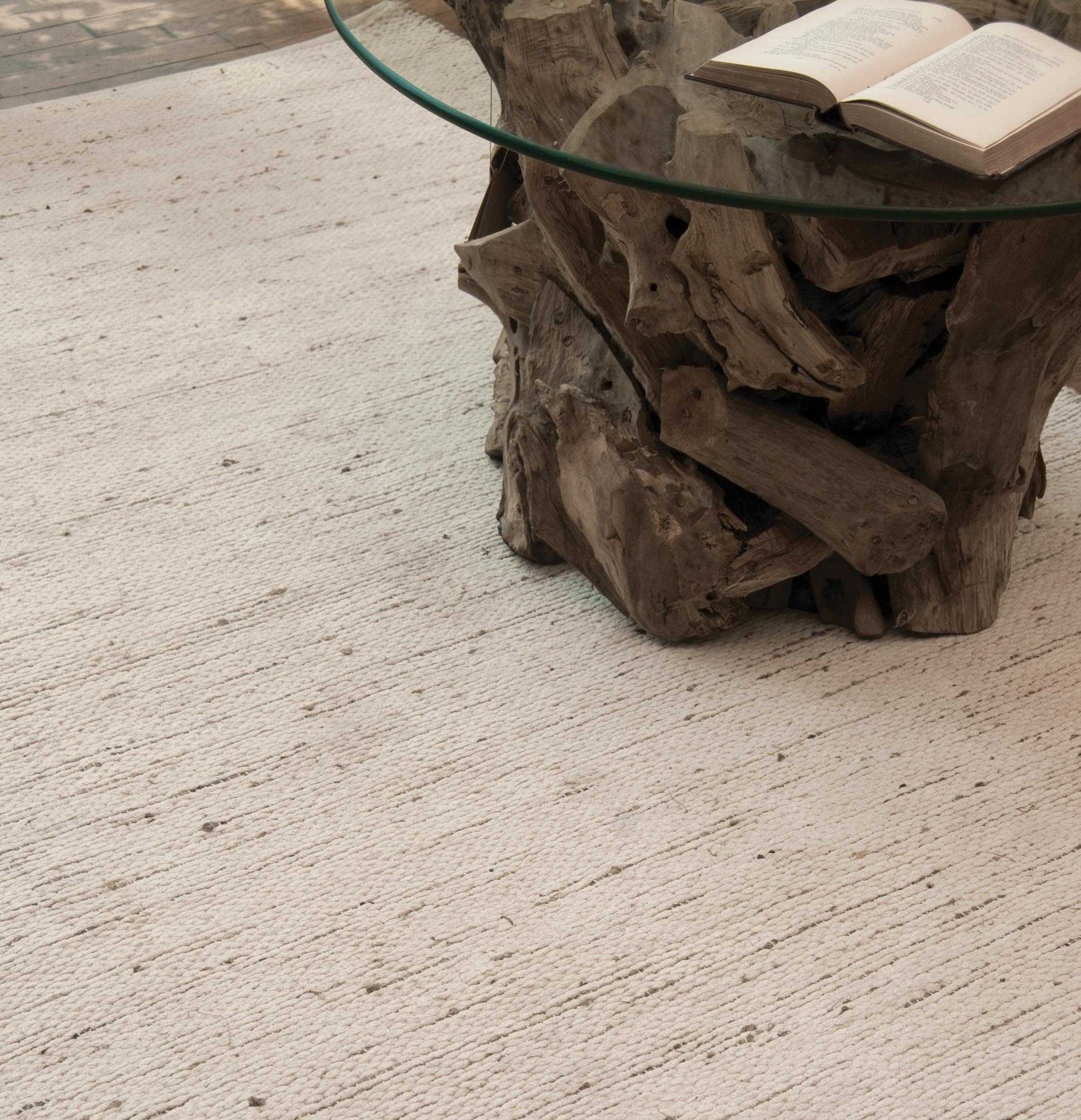Grey beige rug with coffee table.