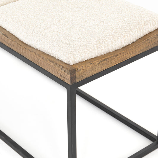 Tri-seat boucle entryway bench with rug and dog in the entryway of a home with a photo of marfa.