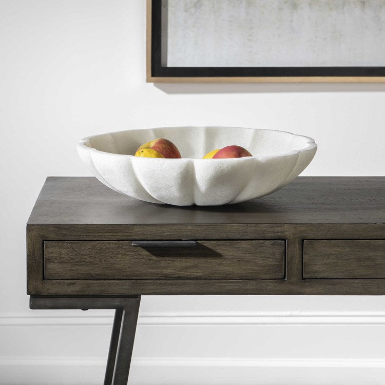 Large white decorative bowl on wooden console.
