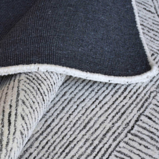 Nautical rug with navy and white geometric design.