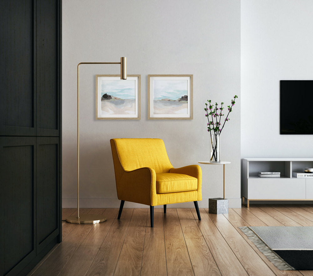 Two coastal art prints in from of a yellow chair in a modern, luxury Newport Beach home.