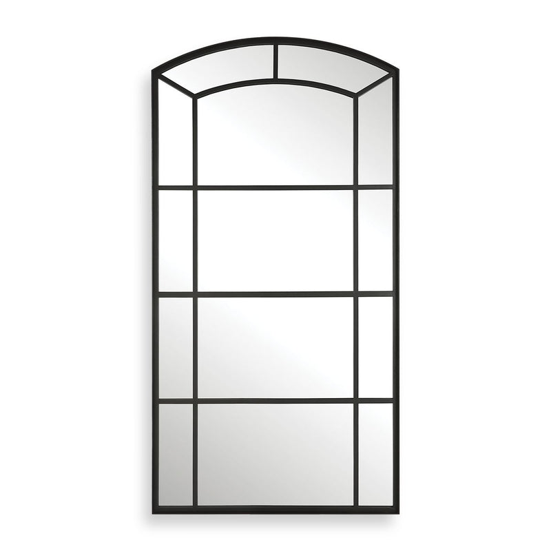 Black arch mirror leaning against a living room wall