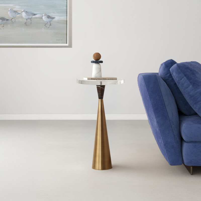 Cocktail table with decorative object and blue sofa.