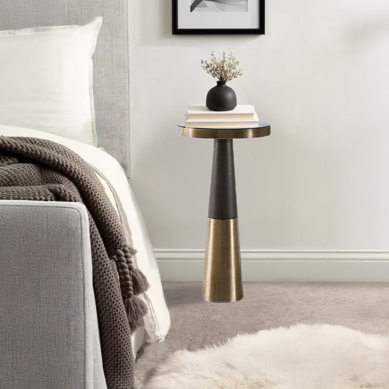 Bedroom end table with brushed brass and books and vase to decorate.