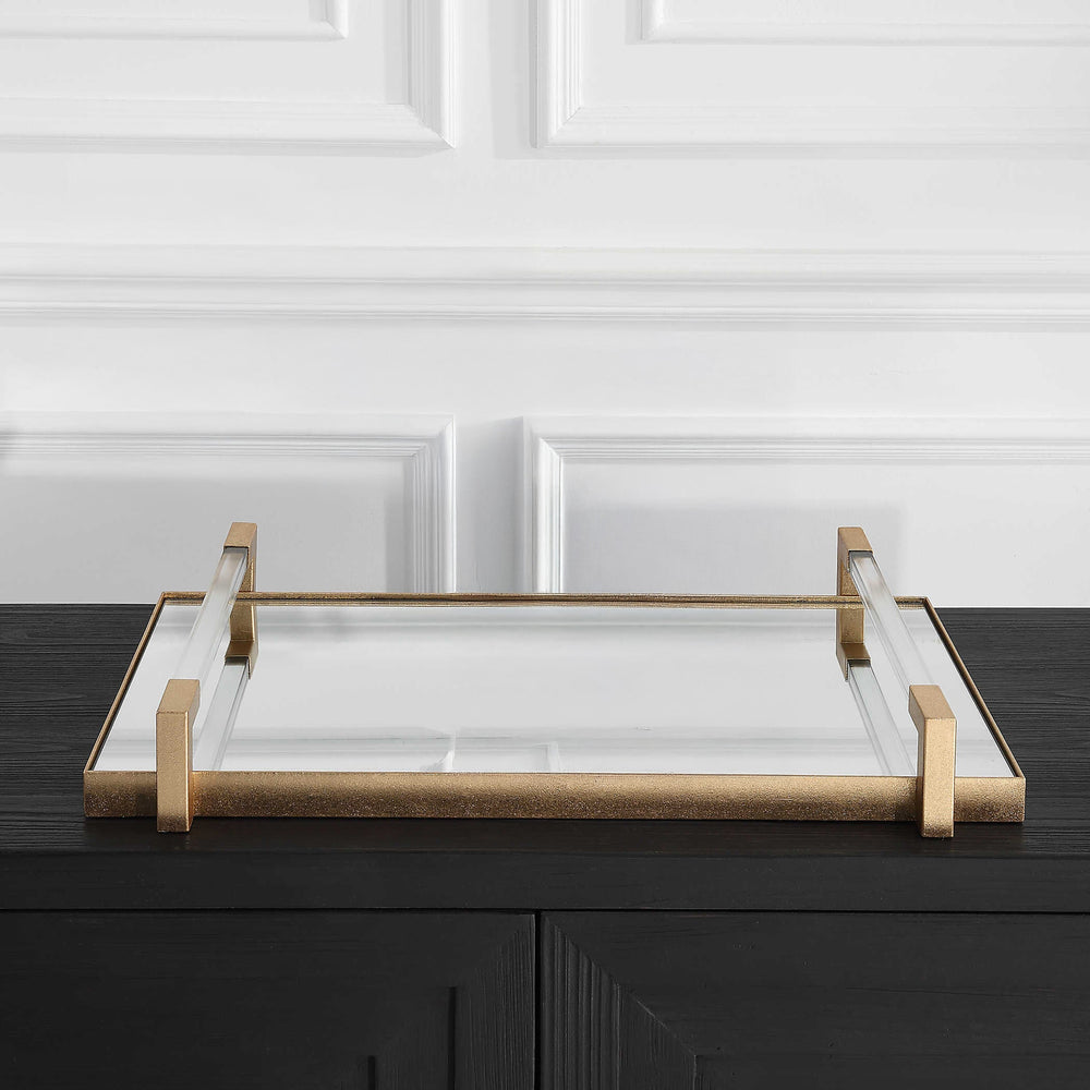 Mirrored Gold Tray with Acrylic Handles on a black console with white walls.