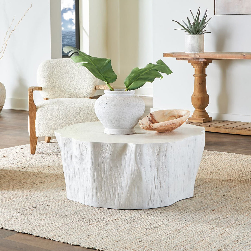 White coastal coffee table and wood console table in a living room.