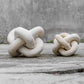 Limestone link sculptures styled on a shelf