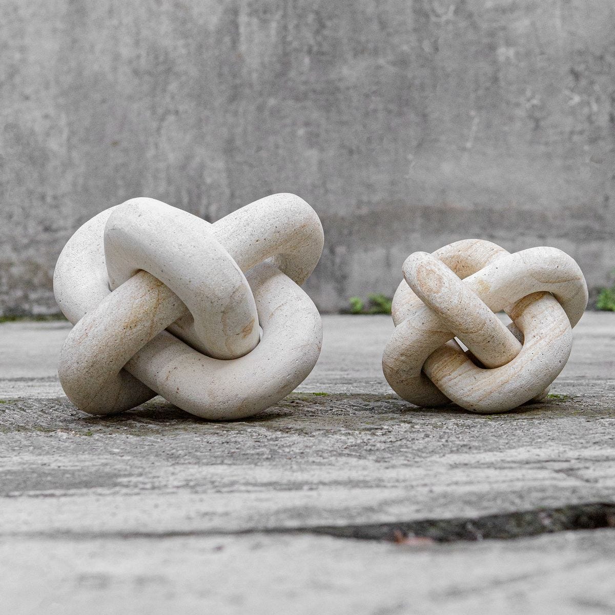 Limestone link sculptures styled on a shelf