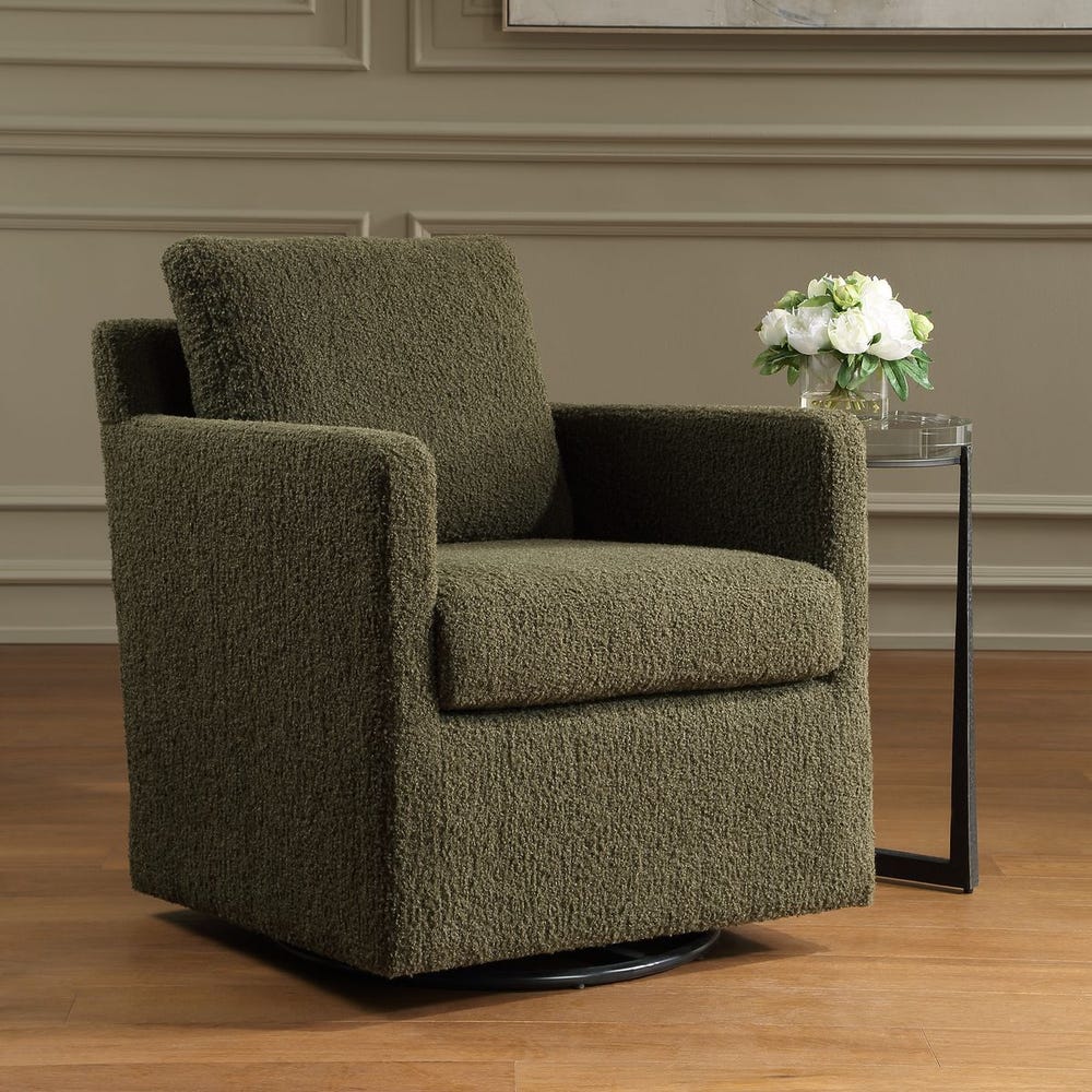 Green armchair in a room with a side table and flowers