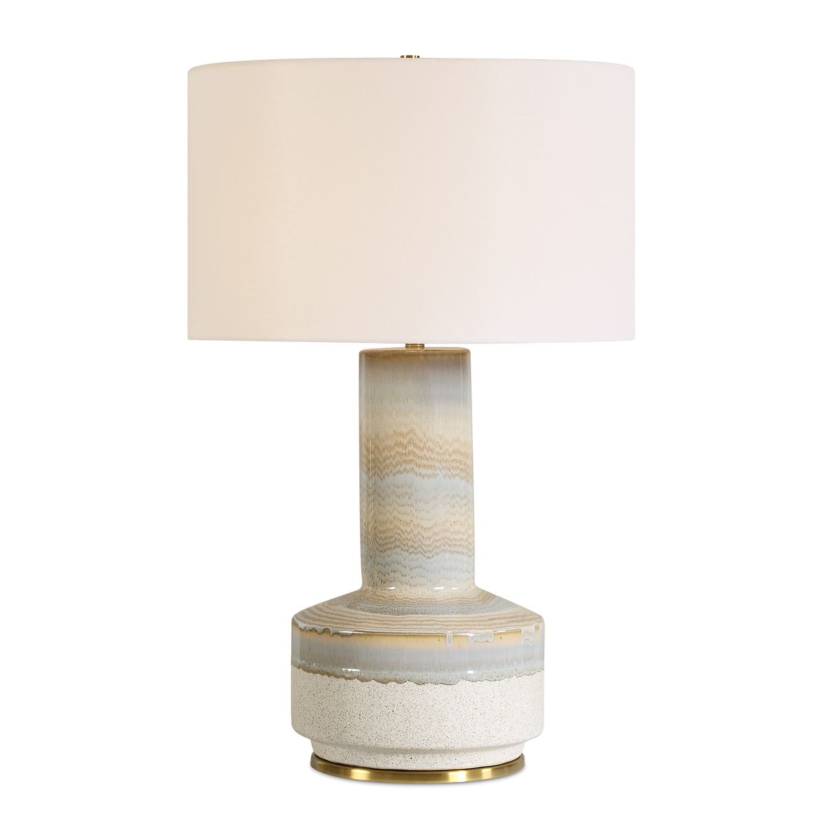 Table lamp with a textured ceramic base and white shade on a white background